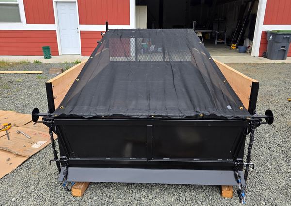 Mesh roll-out tarp pulled over a loaded insert